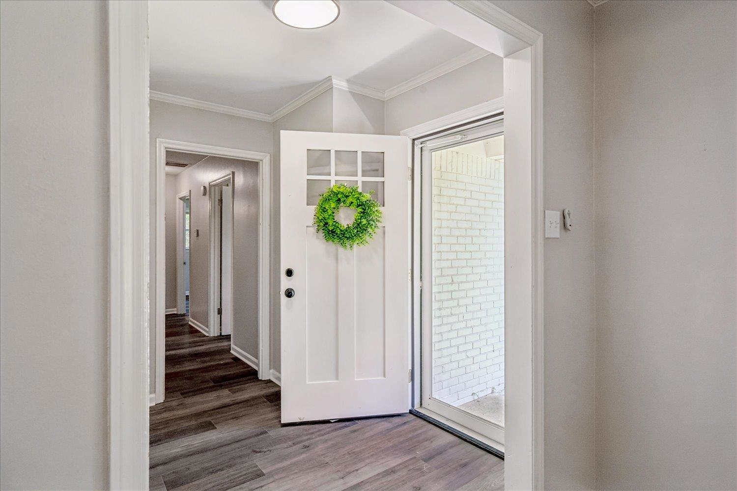 3351 Oak Road Bartlett, TN 38135 - Photo 8 of 30 Entryway featuring a white paneled door with windowpanes, a storm door, wood-finish flooring, and light-toned wall paint