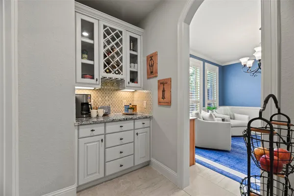 a spacious bedroom with a bed and a chandelier
