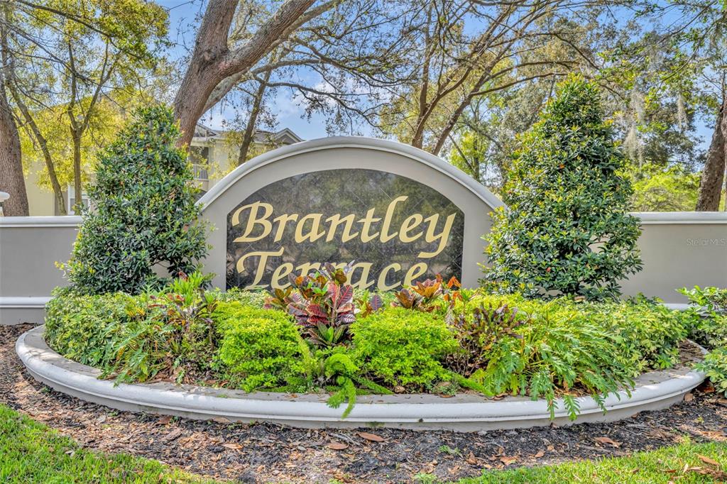 582 Brantley Terrace Way, Unit 304 Altamonte Springs, FL 32714 - Photo 4 of 30 a sign that is in front of flowers