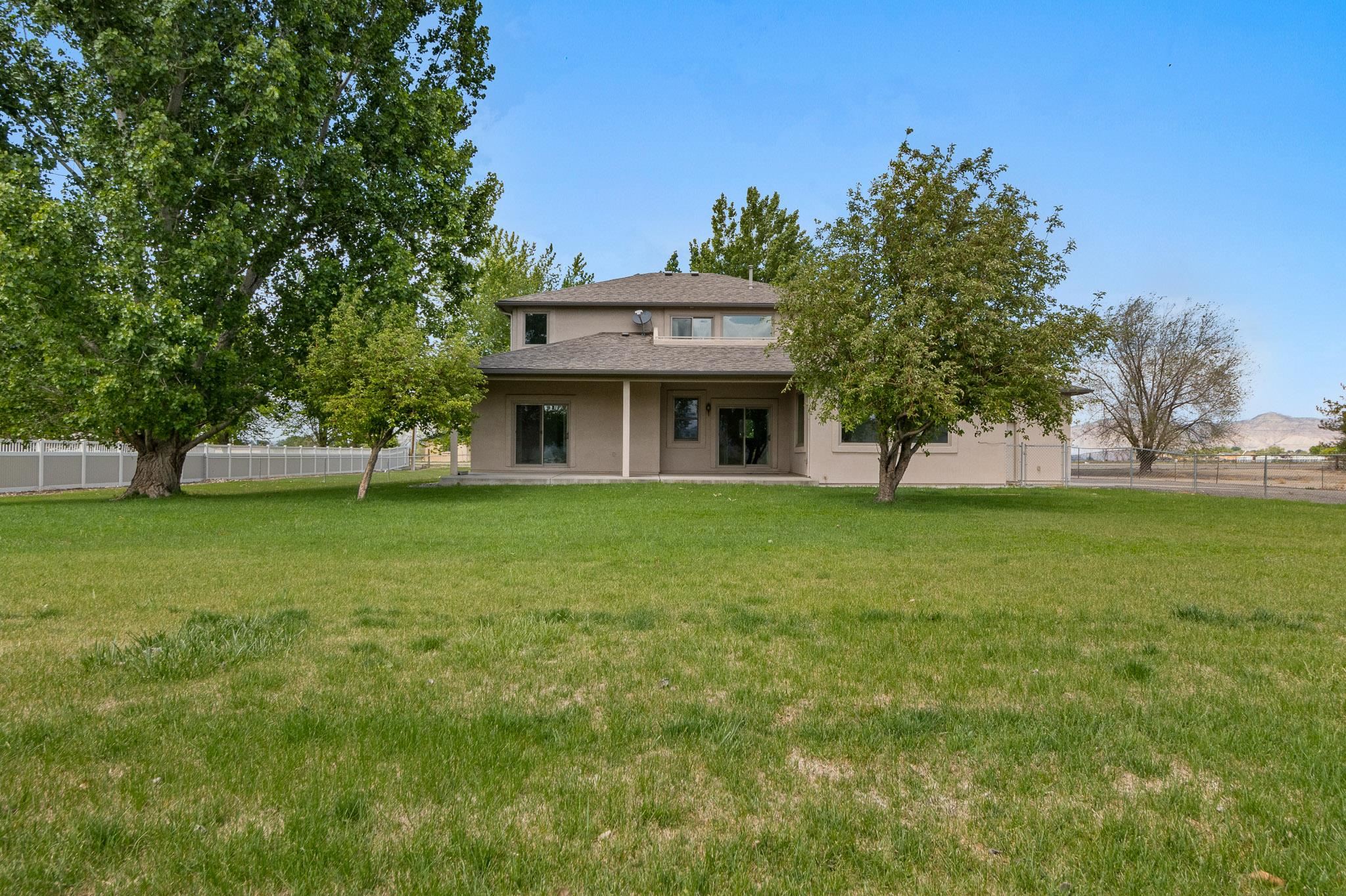 2107 I I- 1/2 Road Grand Junction, CO 81505 - Photo 37 of 42 a front view of a house with a yard
