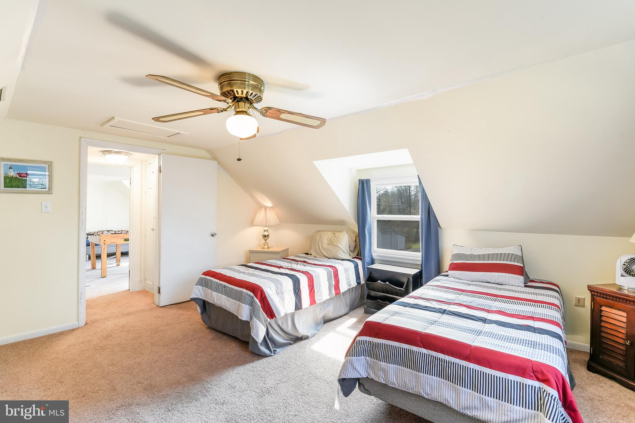 23690 West Patuxent Beach Road California, MD 20619 - Photo 20 of 39 a bedroom with two beds and ceiling fan