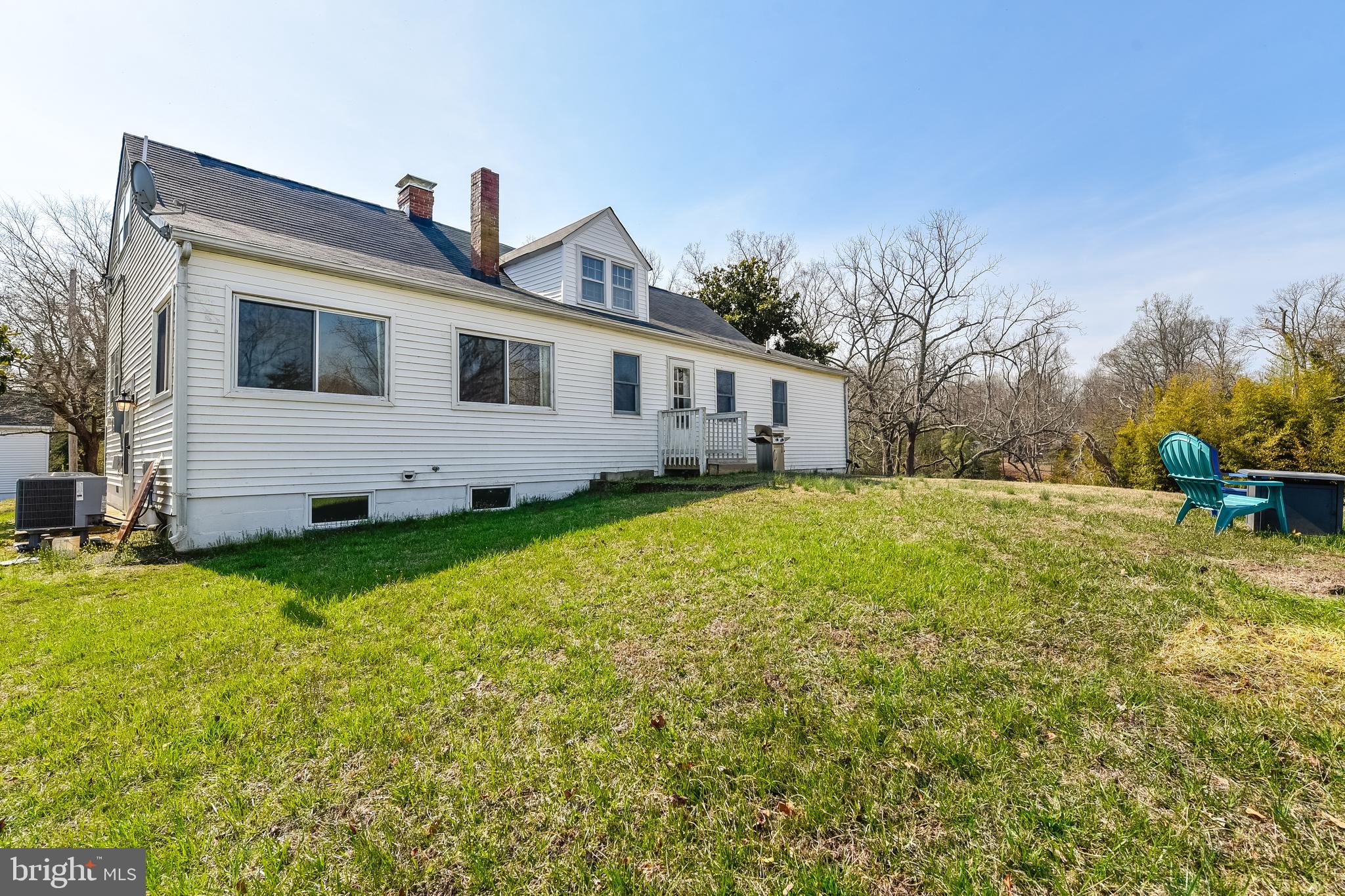 23690 West Patuxent Beach Road California, MD 20619 - Photo 21 of 39 a front view of house with yard and trees in the background