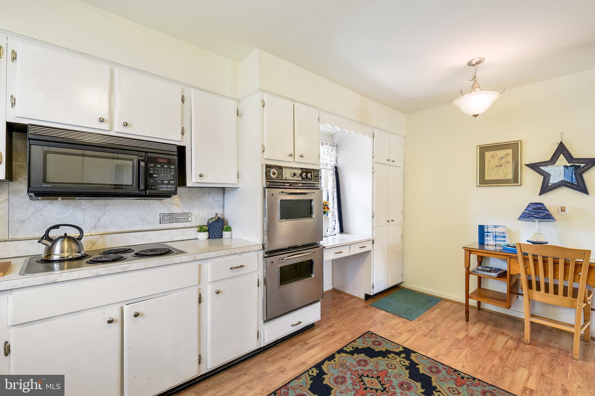23690 West Patuxent Beach Road California, MD 20619 - Photo 28 of 39 a kitchen with stainless steel appliances and wooden cabinets