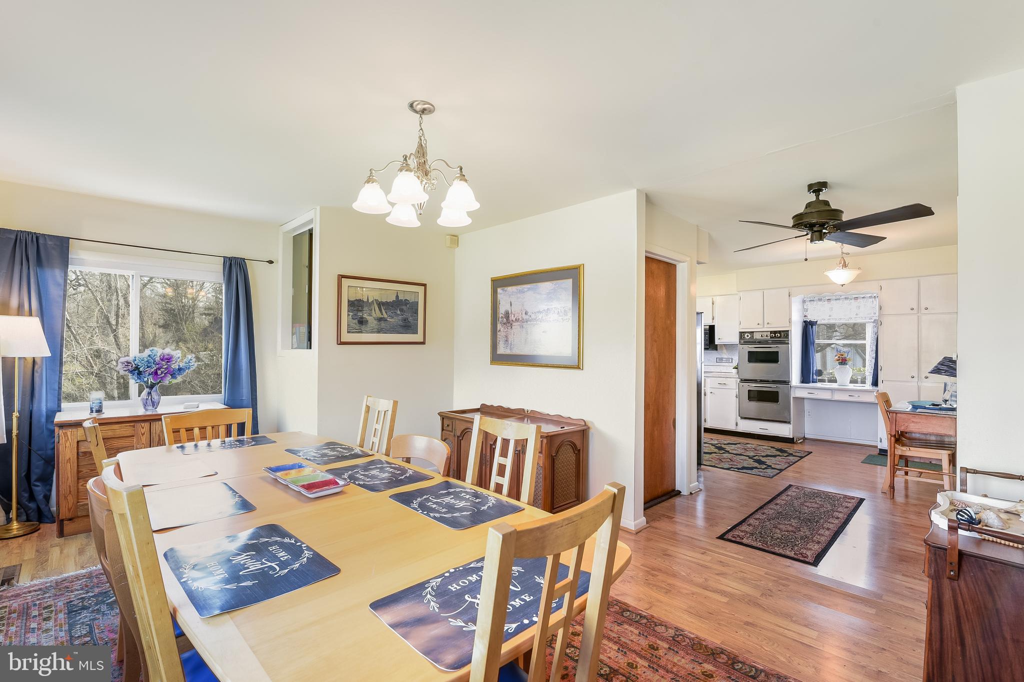 23690 West Patuxent Beach Road California, MD 20619 - Photo 29 of 39 a view of a dining room with furniture a chandelier and wooden floor