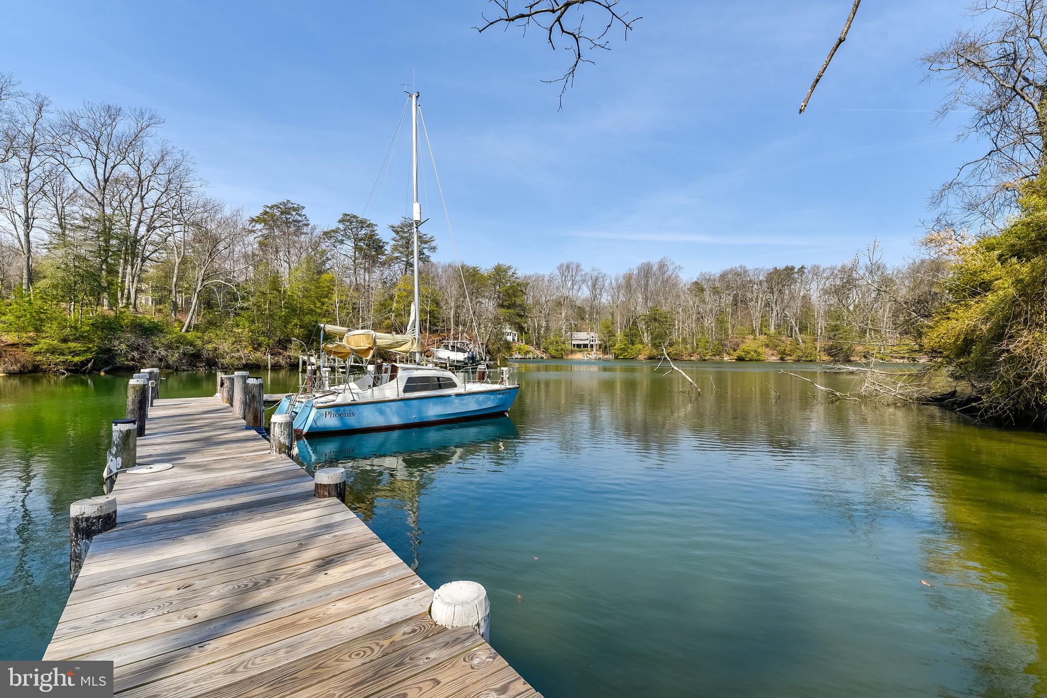 23690 West Patuxent Beach Road California, MD 20619 - Photo 4 of 39 a view of a lake with boats and trees in the background