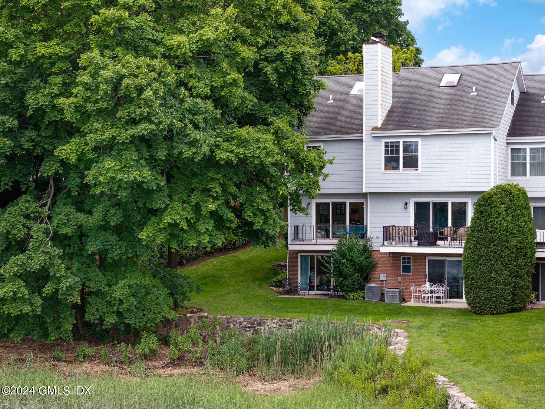 100 Strickland Road, Unit 10 Cos Cob, CT 06807 - Photo 18 of 26 a view of house with outdoor space and swimming pool