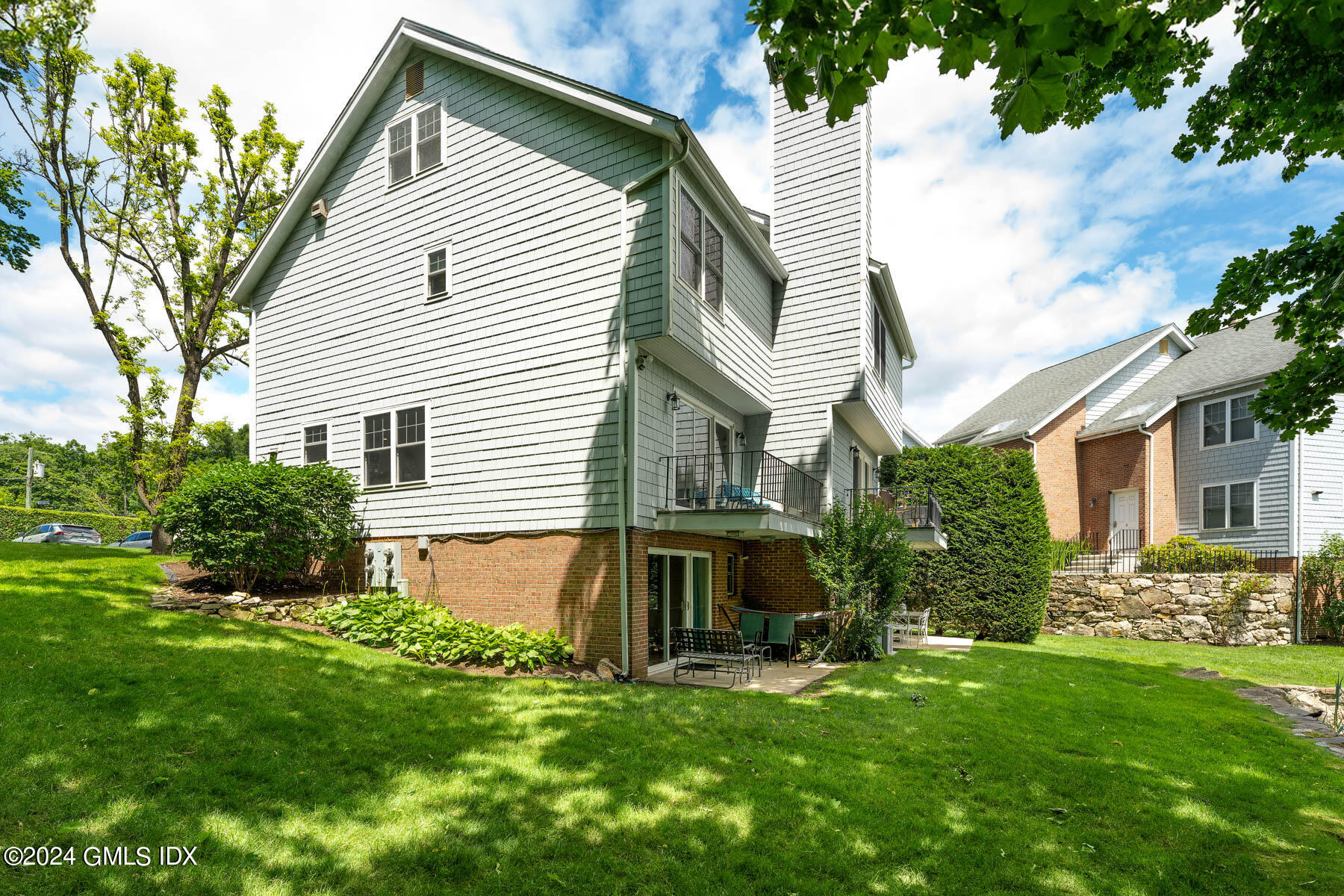 100 Strickland Road, Unit 10 Cos Cob, CT 06807 - Photo 19 of 26 a view of a house with a yard