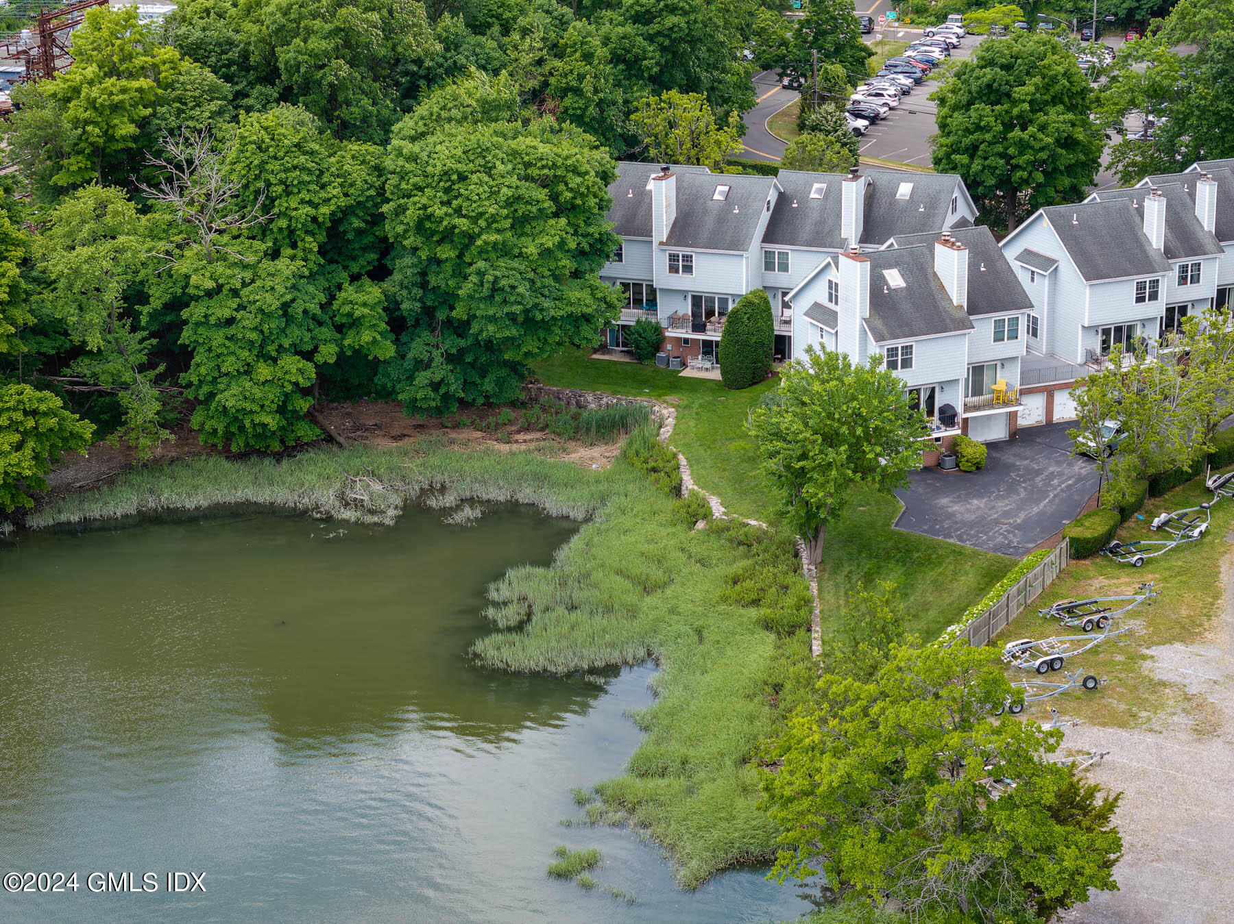 100 Strickland Road, Unit 10 Cos Cob, CT 06807 - Photo 20 of 26 an aerial view of residential houses with outdoor space and lake view