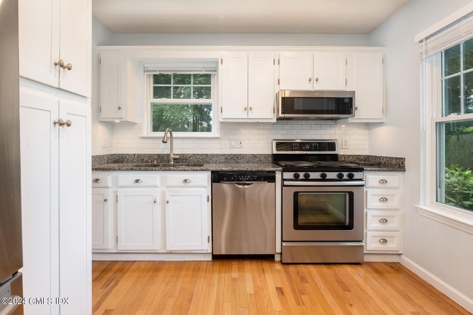 100 Strickland Road, Unit 10 Cos Cob, CT 06807 - Photo 6 of 26 a kitchen with cabinets appliances and a window