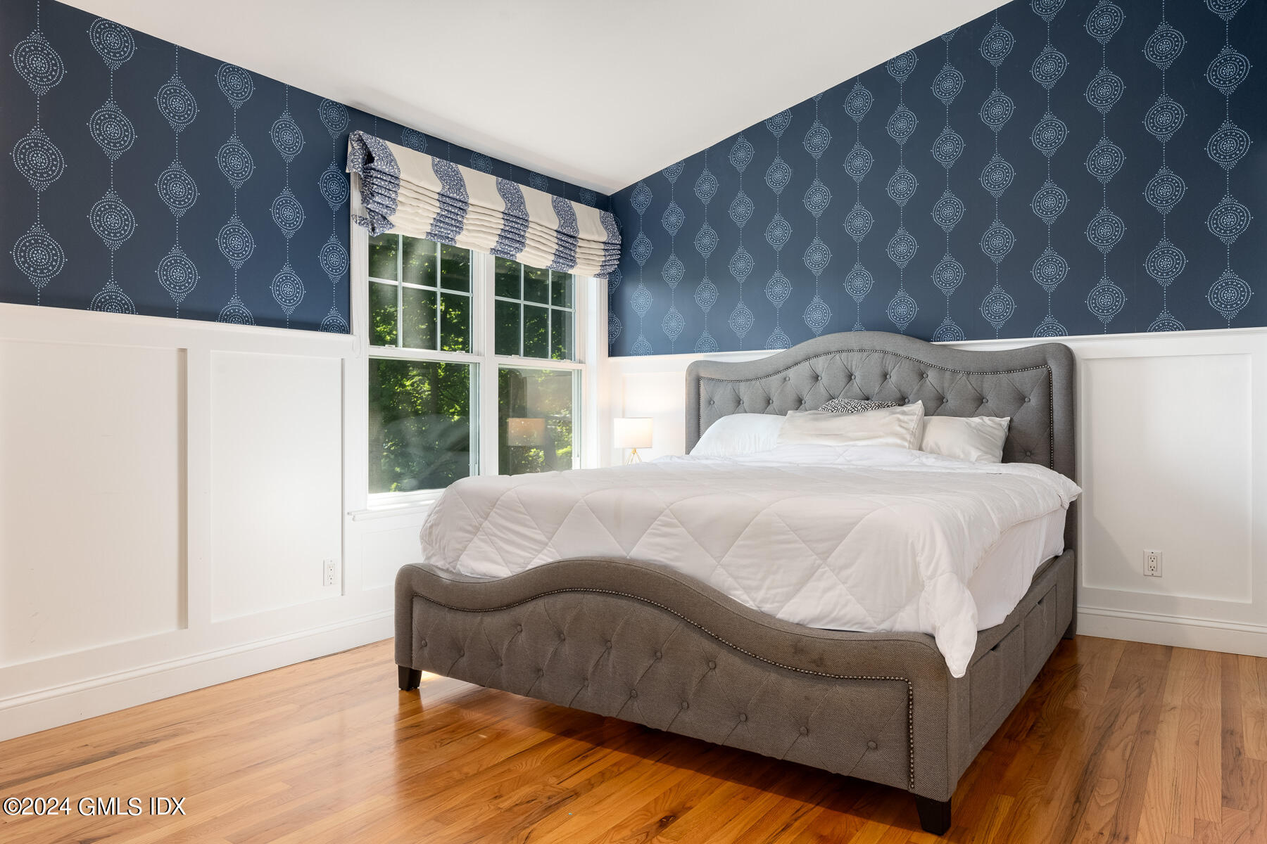 100 Strickland Road, Unit 10 Cos Cob, CT 06807 - Photo 8 of 26 a large bed sitting in a bedroom next to a window