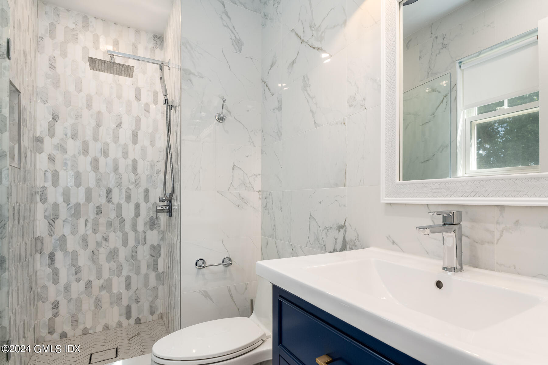 100 Strickland Road, Unit 10 Cos Cob, CT 06807 - Photo 10 of 26 a bathroom with a sink a toilet and shower