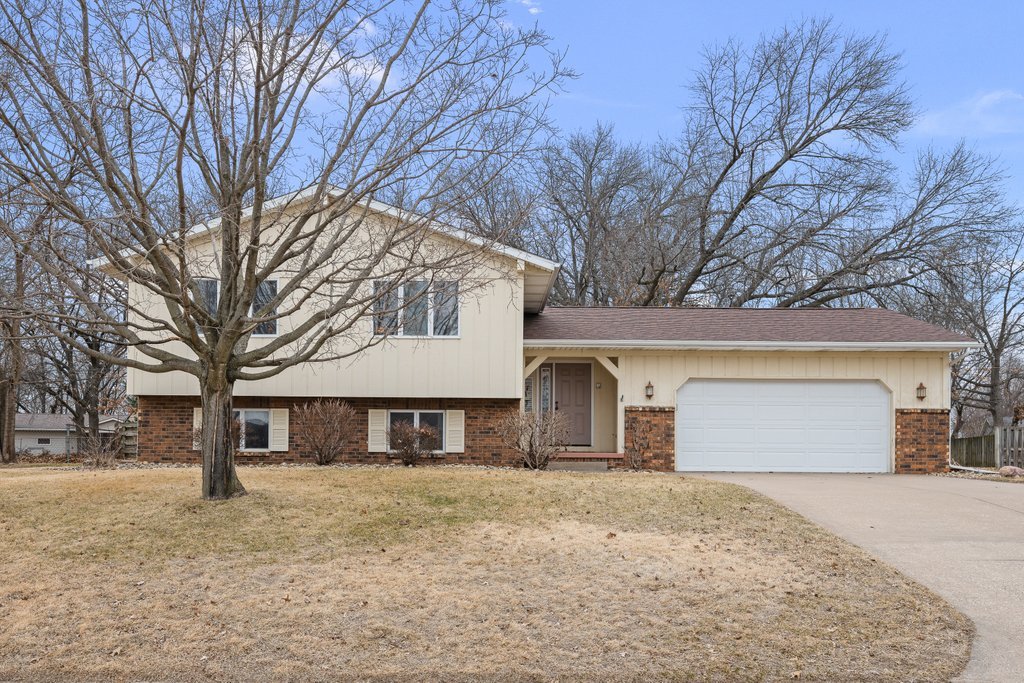 a front view of house with a yard covered with snow