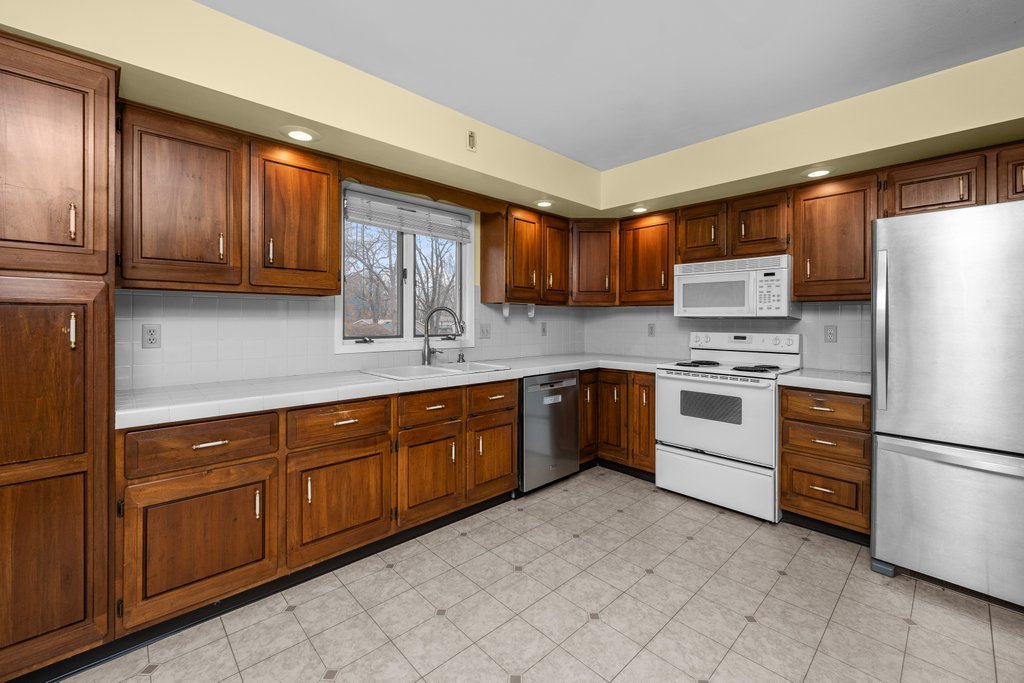 1141 Mark Street Colona, IL 61241 - Photo 12 of 29 a kitchen with stainless steel appliances granite countertop a refrigerator sink and stove