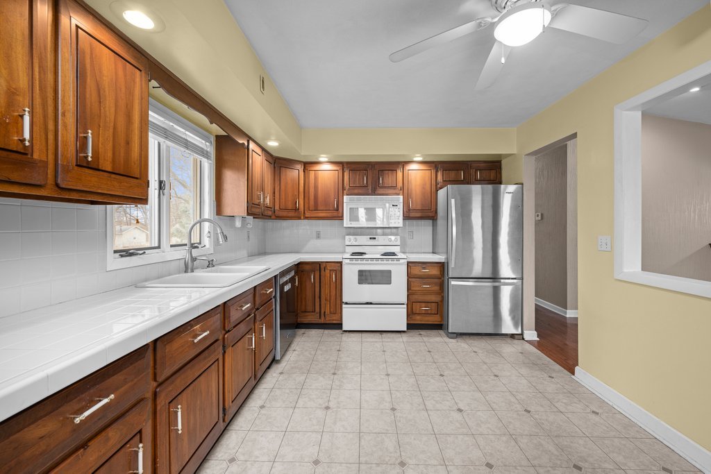 1141 Mark Street Colona, IL 61241 - Photo 13 of 29 a kitchen with refrigerator cabinets and a sink