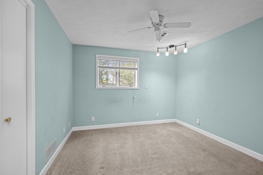 1141 Mark Street Colona, IL 61241 - Photo 24 of 29 an empty room with a window and a ceiling fan