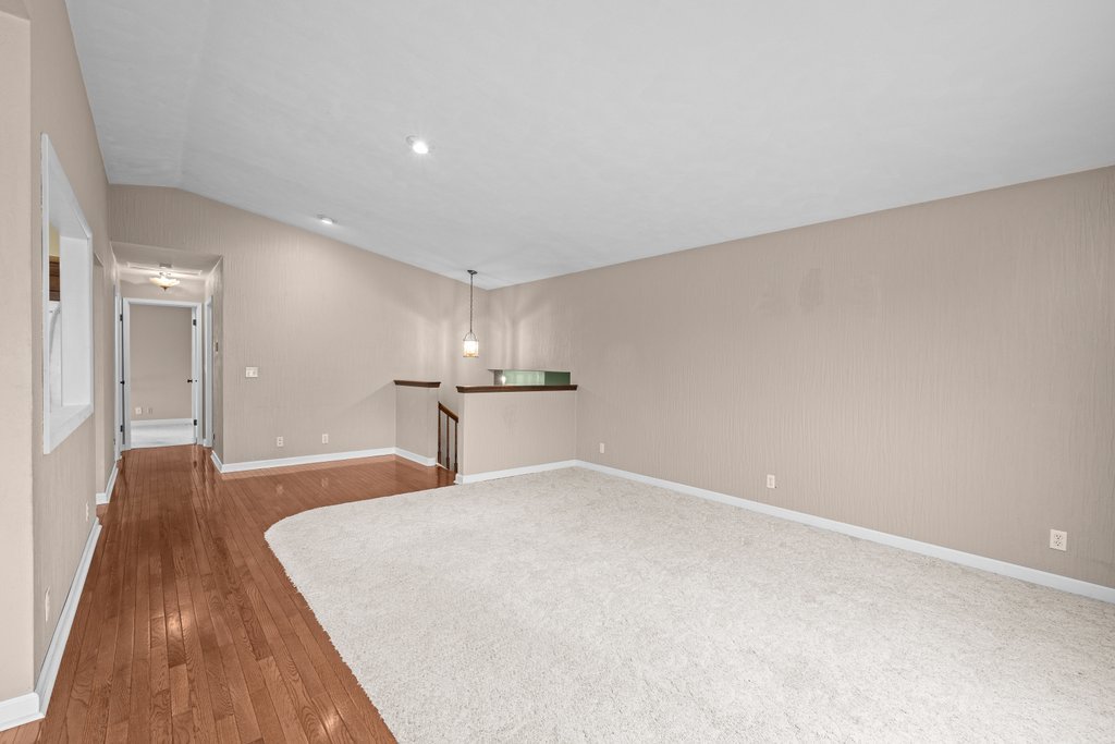 1141 Mark Street Colona, IL 61241 - Photo 8 of 29 a big room with wooden floor and bench