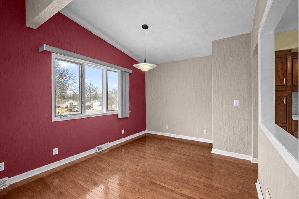 1141 Mark Street Colona, IL 61241 - Photo 10 of 29 a view of an empty room with a window and wooden floor