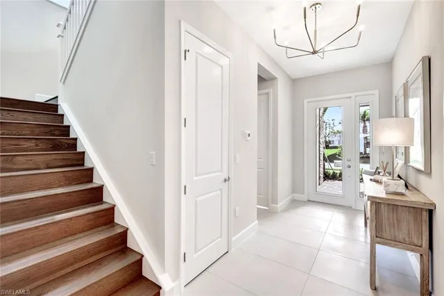 a view of an entryway with kitchen and workspace