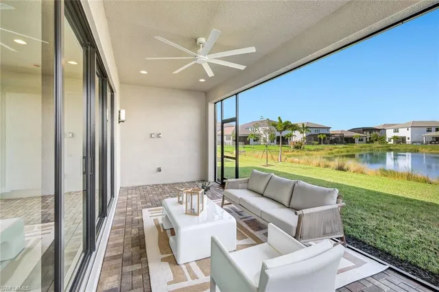 a view of swimming pool from balcony with seating space