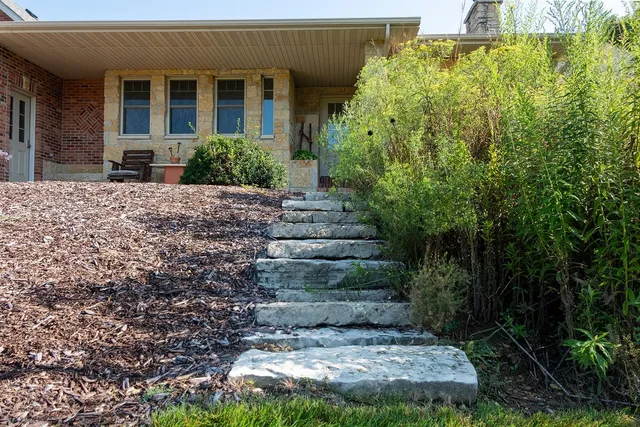 a view of a livingroom with wooden floor and a staircase