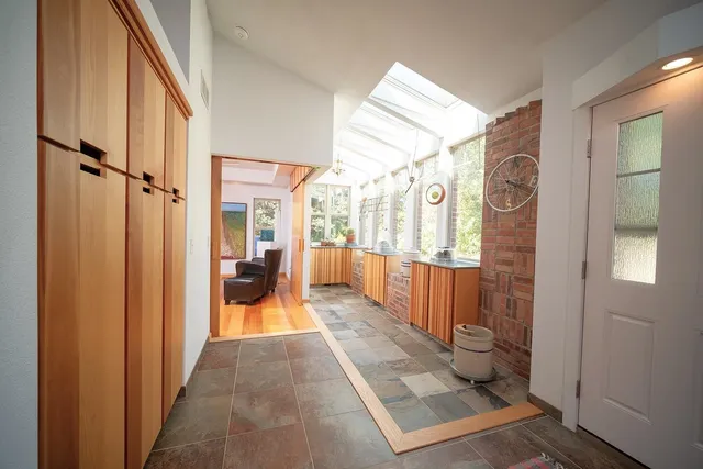 a bathroom with a granite countertop sink and a large mirror
