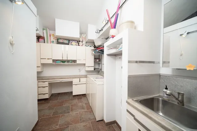 a view of a livingroom with furniture and a mirror