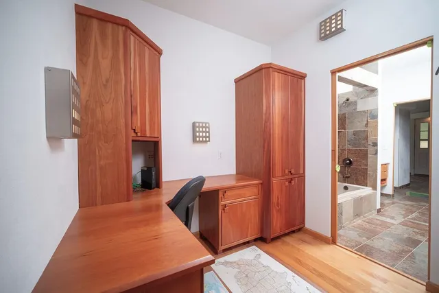 a bed sitting in a bedroom next to a window