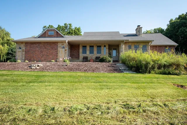 a front view of house with yard and outdoor seating