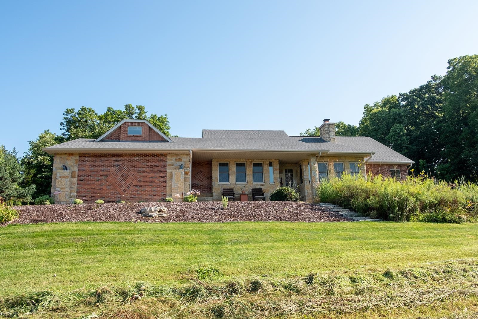 7822 Burr Oak Road Roscoe, IL 61073 - Photo 7 of 53 a front view of house with yard and outdoor seating