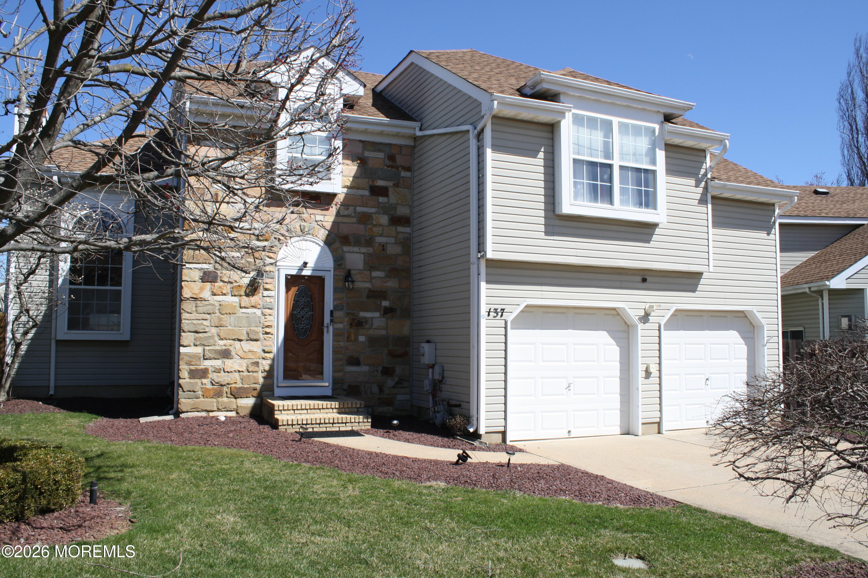 137 Kentucky Way Freehold, NJ 07728 - Photo 31 of 31 a front view of a house with a yard and garage