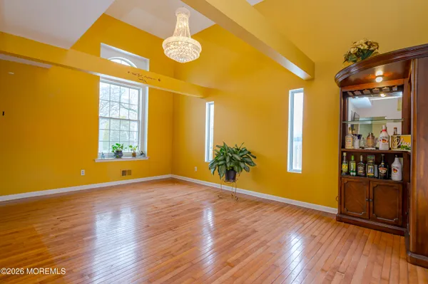 a room with stainless steel appliances kitchen island granite countertop furniture and a refrigerator