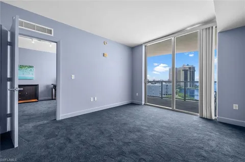 an empty room with sliding door and a yard