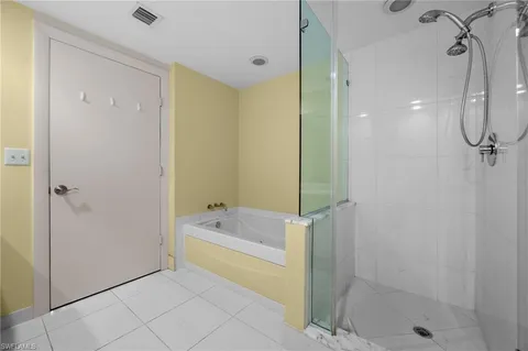 a bathroom with a tub shower and a sink