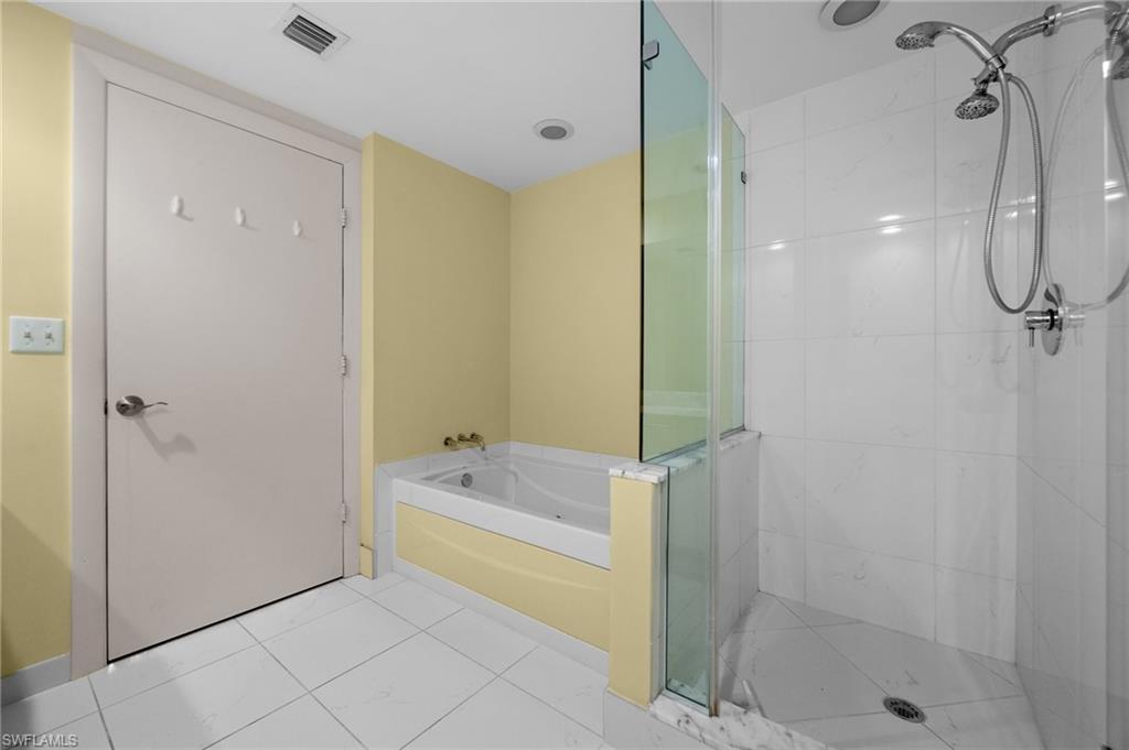 3000 Oasis Grand Boulevard, Unit 906 Fort Myers, FL 33916 - Photo 16 of 21 a bathroom with a tub shower and a sink