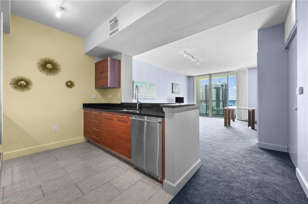 3000 Oasis Grand Boulevard, Unit 906 Fort Myers, FL 33916 - Photo 2 of 21 a kitchen with a sink and cabinets