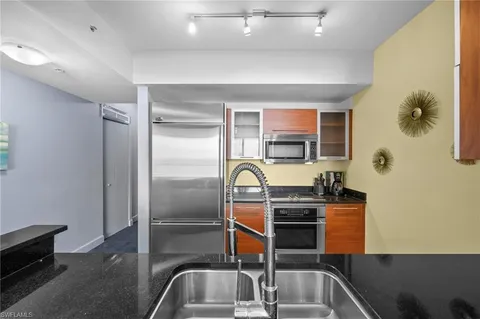 a kitchen with a refrigerator and a sink