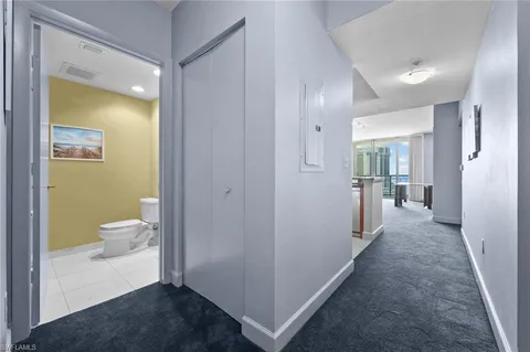 a view of room with a hallway and toilet