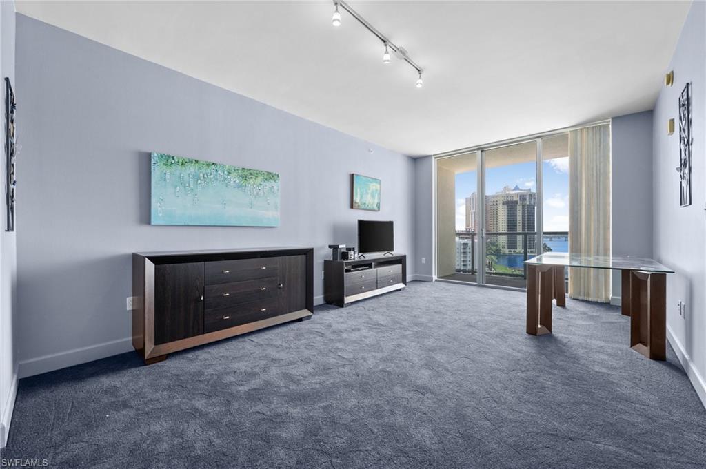 3000 Oasis Grand Boulevard, Unit 906 Fort Myers, FL 33916 - Photo 9 of 21 a living room with furniture and a flat screen tv