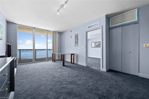 an empty room with windows and closet