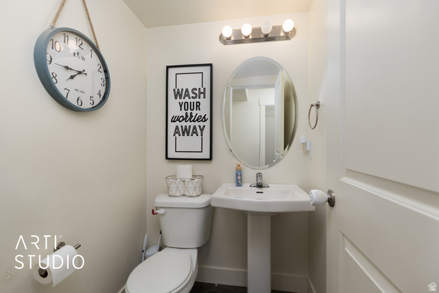 1713 South Windemere Road Santaquin, UT 84655 - Photo 12 of 40 Pedestal sink with a wall-mounted oval mirror and a four-bulb vanity light fixture