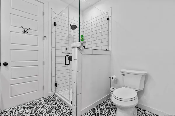 a bathroom with a toilet and a shower