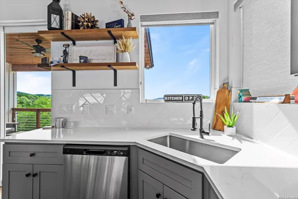 a kitchen with a sink cabinets and window