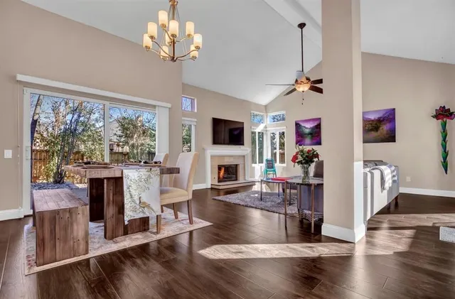 a view of a livingroom with fireplace dining room and wooden floor
