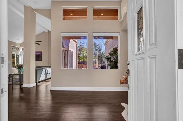 a view of an entryway with wooden floor and windows