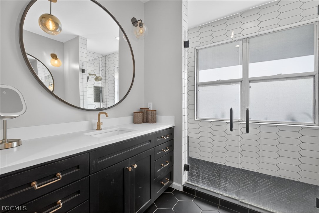 22866 Forest Ridge Drive Estero, FL 33928 - Photo 20 of 38 a bathroom with a double vanity sink and a mirror