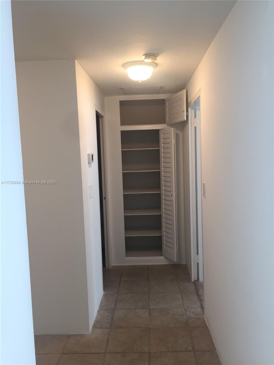 1408 Brickell Bay Drive, Unit 917 Miami, FL 33131 - Photo 12 of 18 a view of walk in closet with empty racks