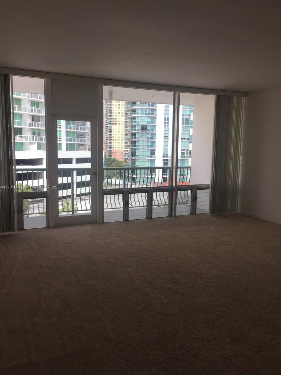1408 Brickell Bay Drive, Unit 917 Miami, FL 33131 - Photo 4 of 18 a view of room with floor to ceiling windows