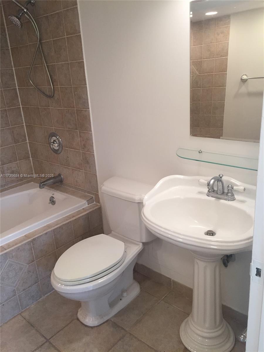 1408 Brickell Bay Drive, Unit 917 Miami, FL 33131 - Photo 10 of 18 a bathroom with a sink toilet and shower