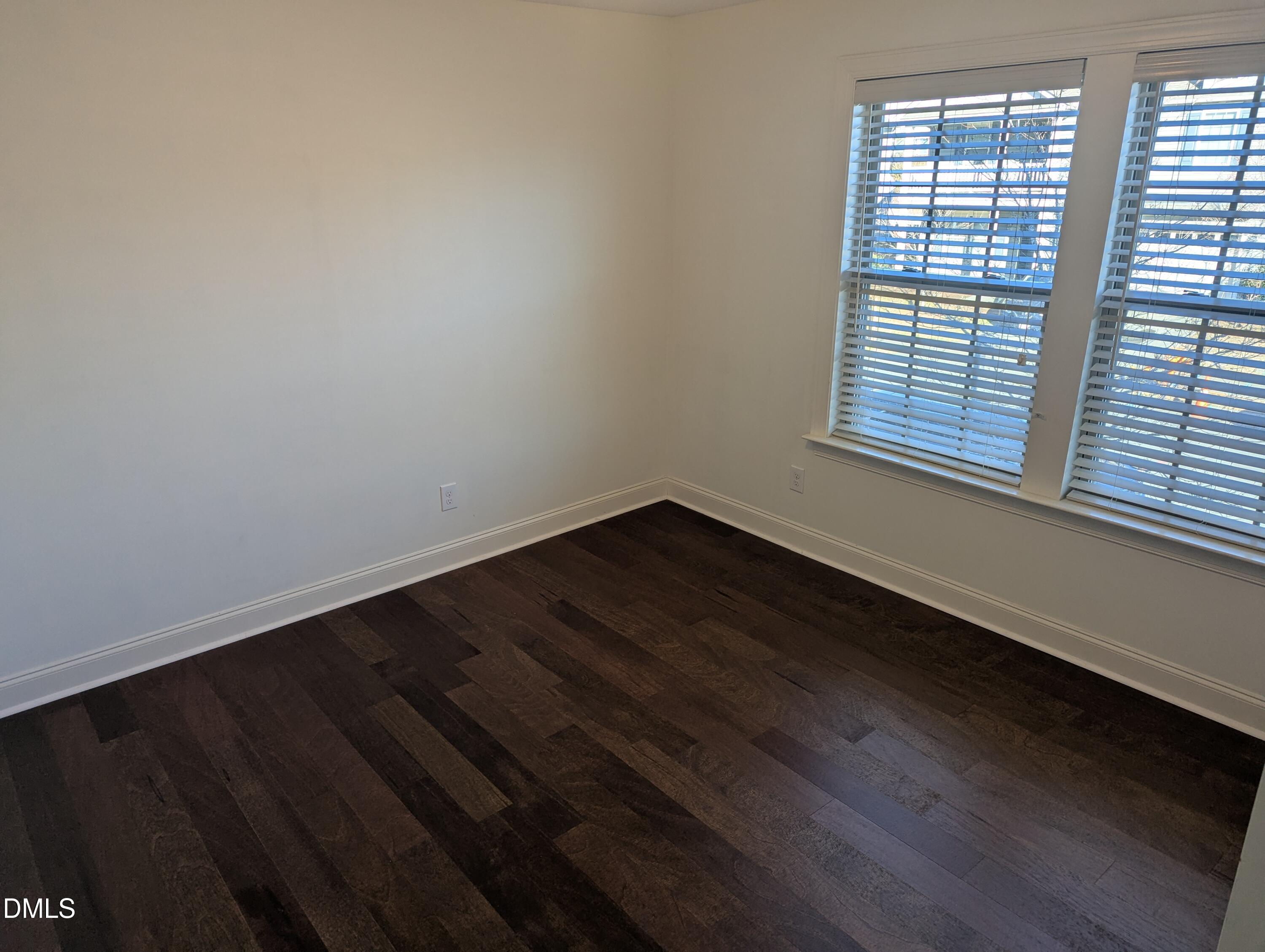 833 Poplar Street Durham, NC 27703 - Photo 13 of 20 an empty room with wooden floor and windows