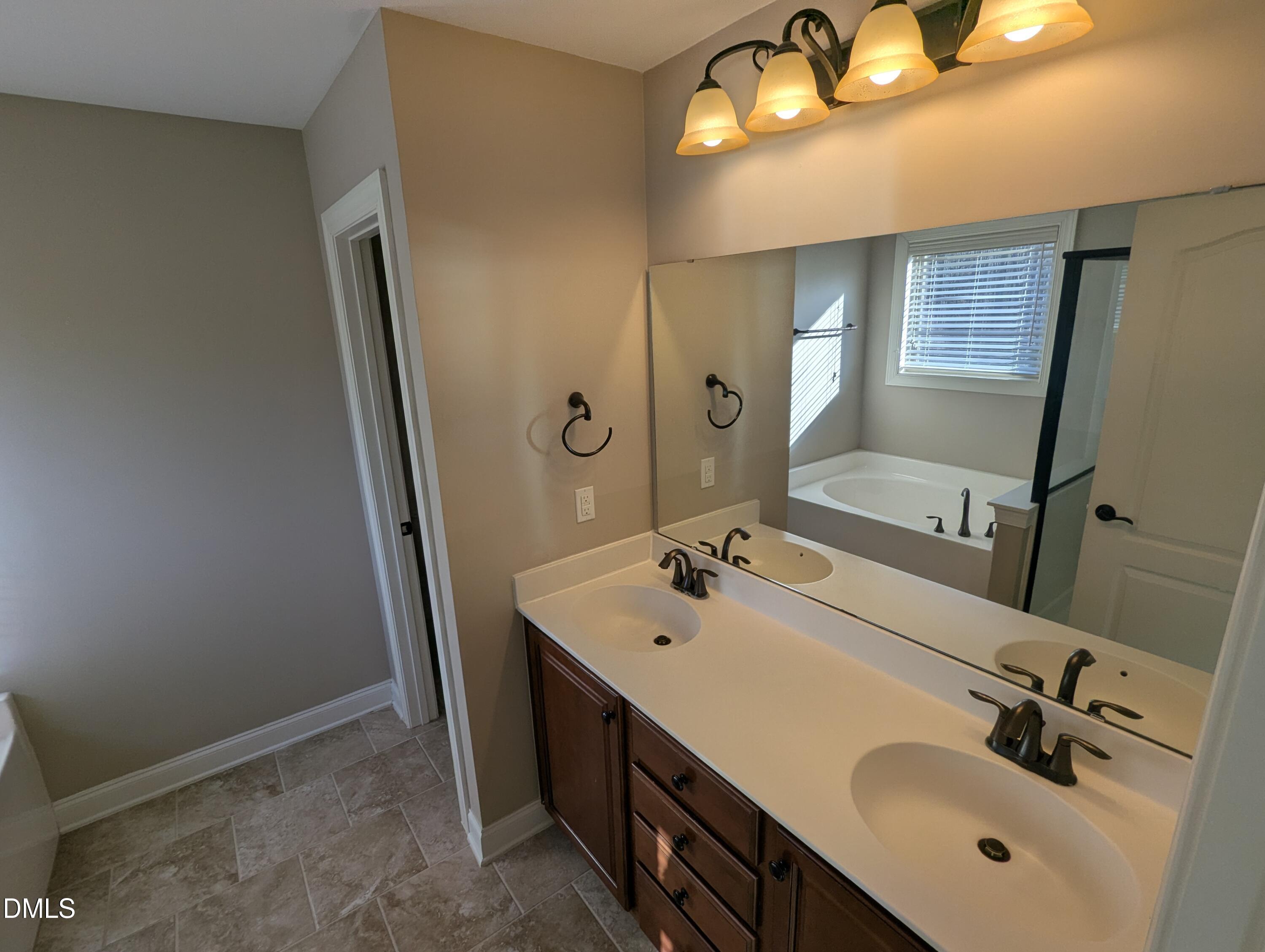 833 Poplar Street Durham, NC 27703 - Photo 16 of 20 a bathroom with a sink vanity and mirror